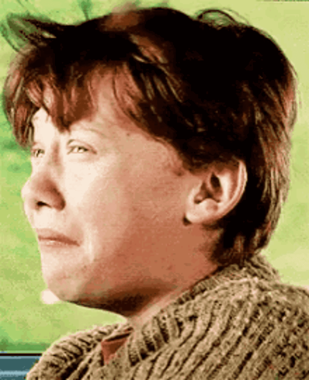 A close up of Ron Weasley as he turns his head to the side with a scared face
