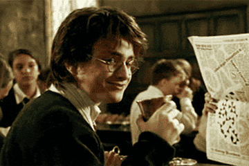 A close up of Harry Potter as juice falls out of his mouth