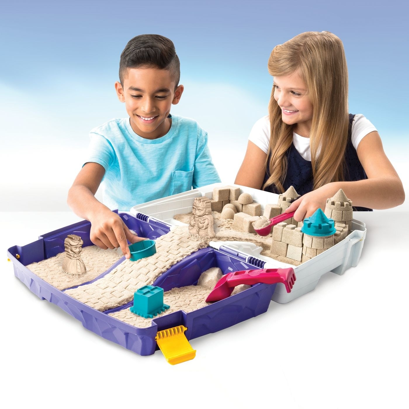 Two children playing with kinetic sand kit