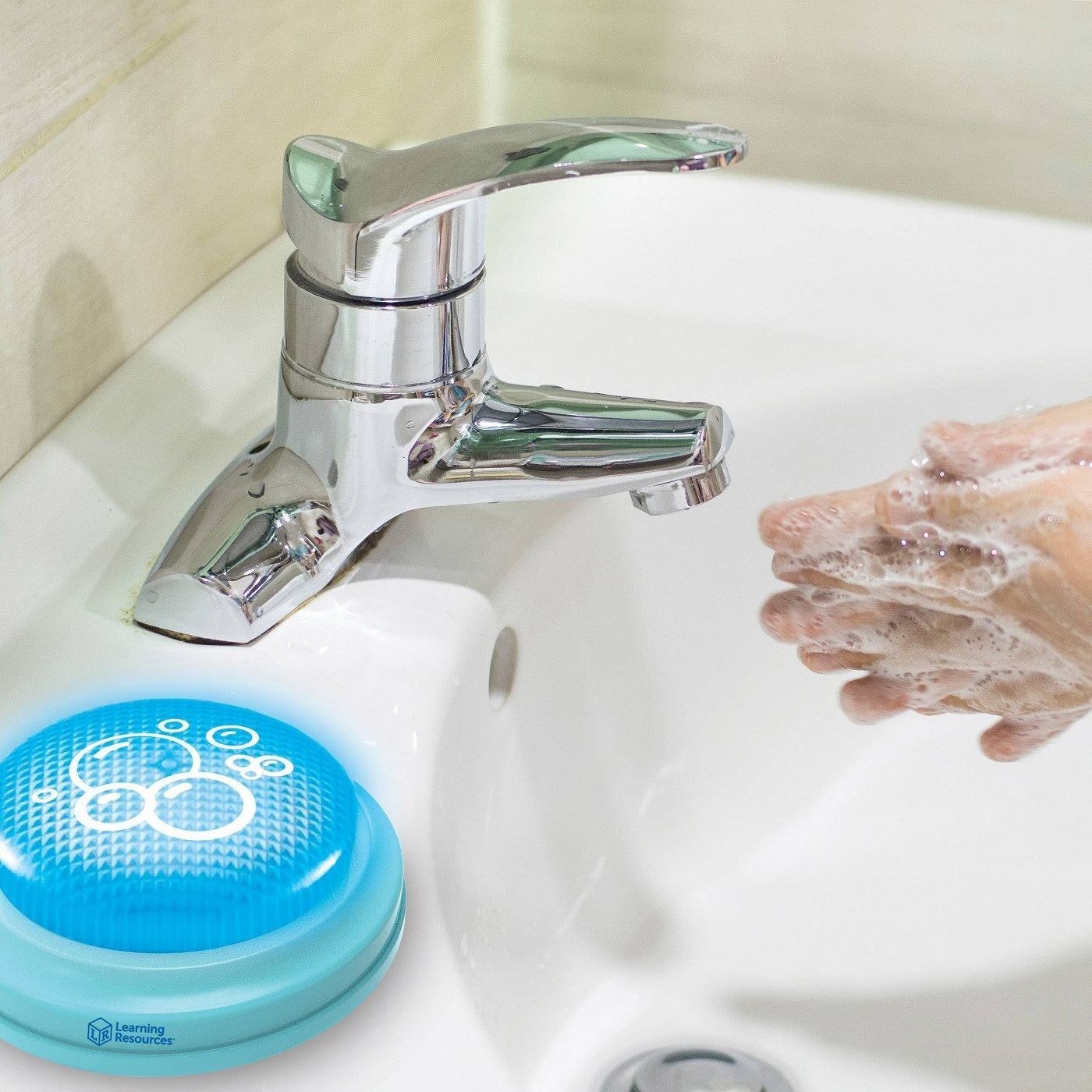 Hand washing timer next to sink with person washing their hands