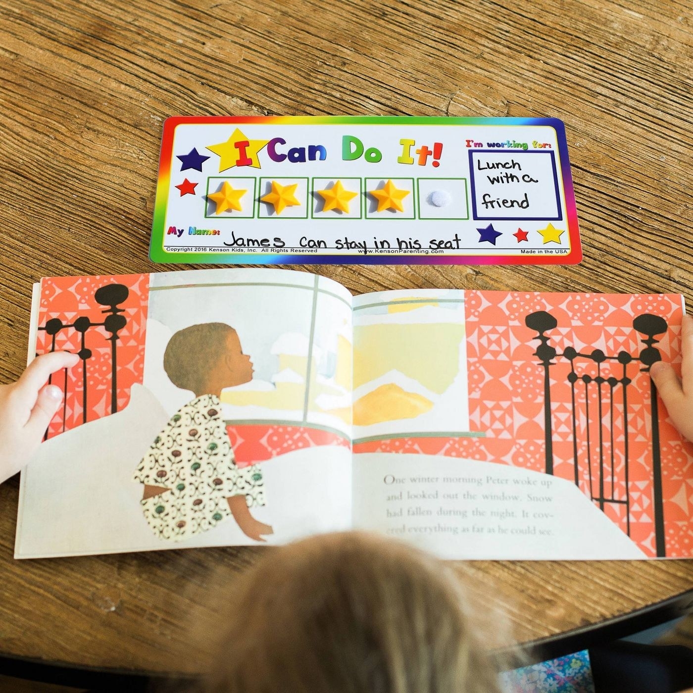 child reading book with star card above
