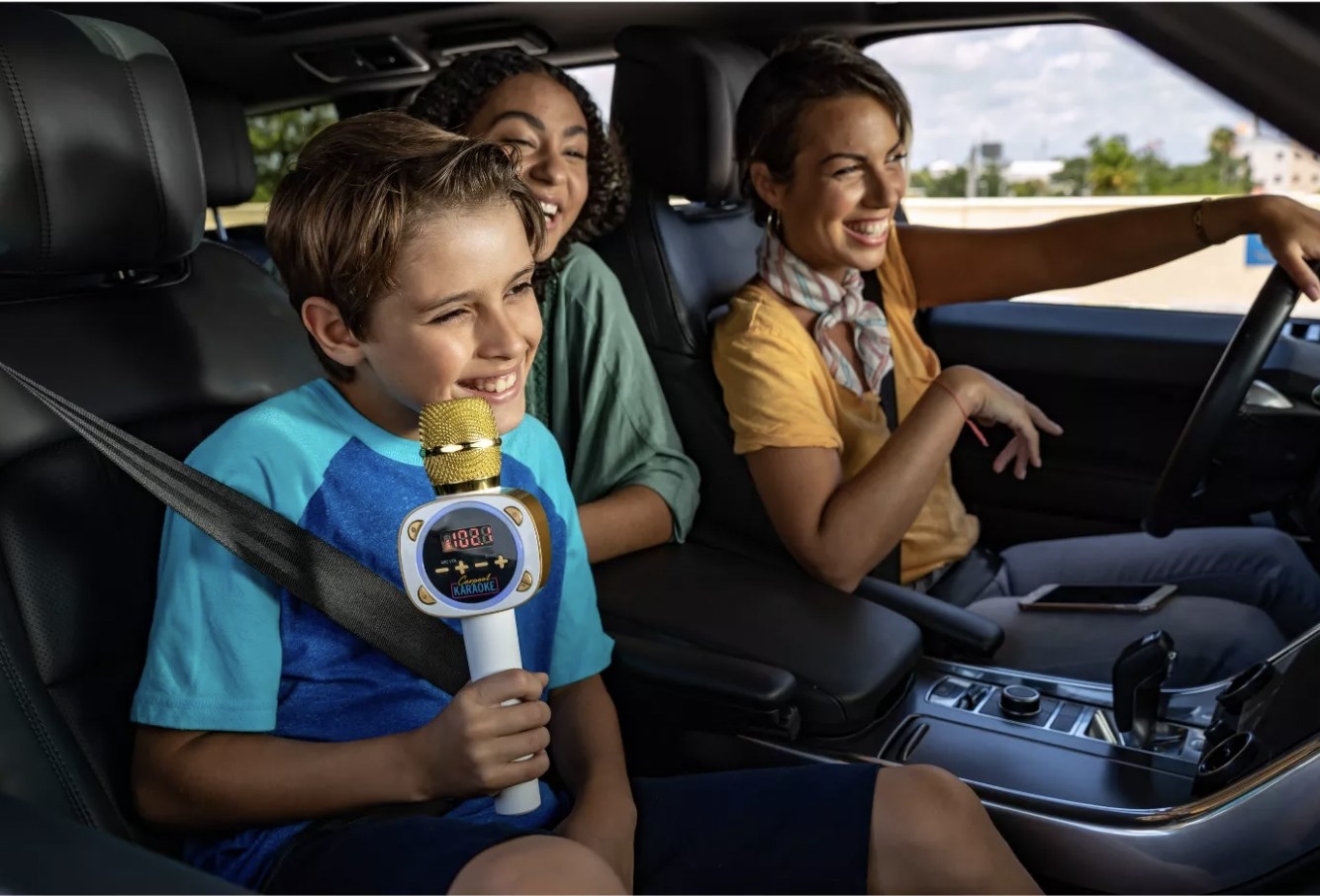 Family in the car using microphone