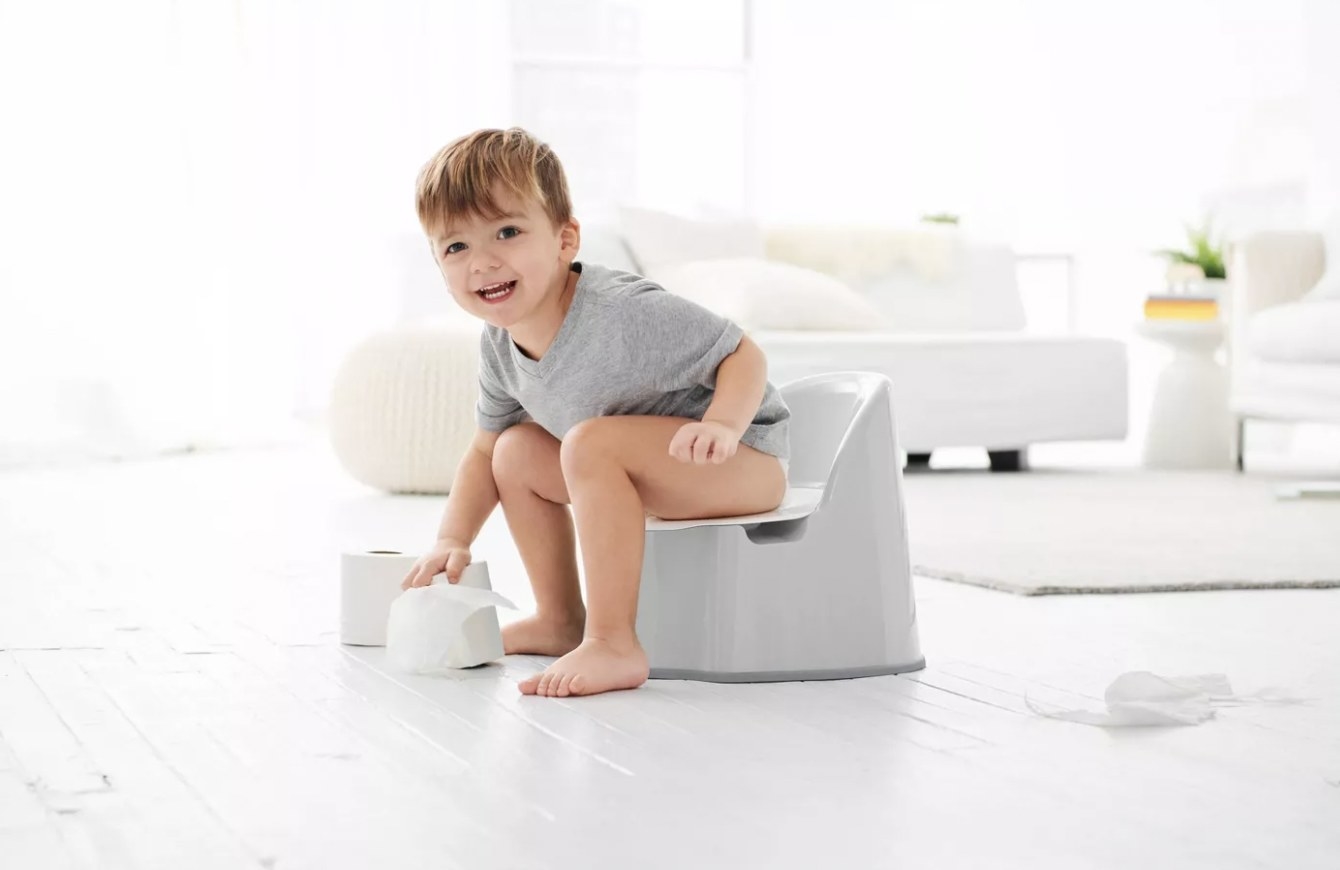 Child sitting on potty chair