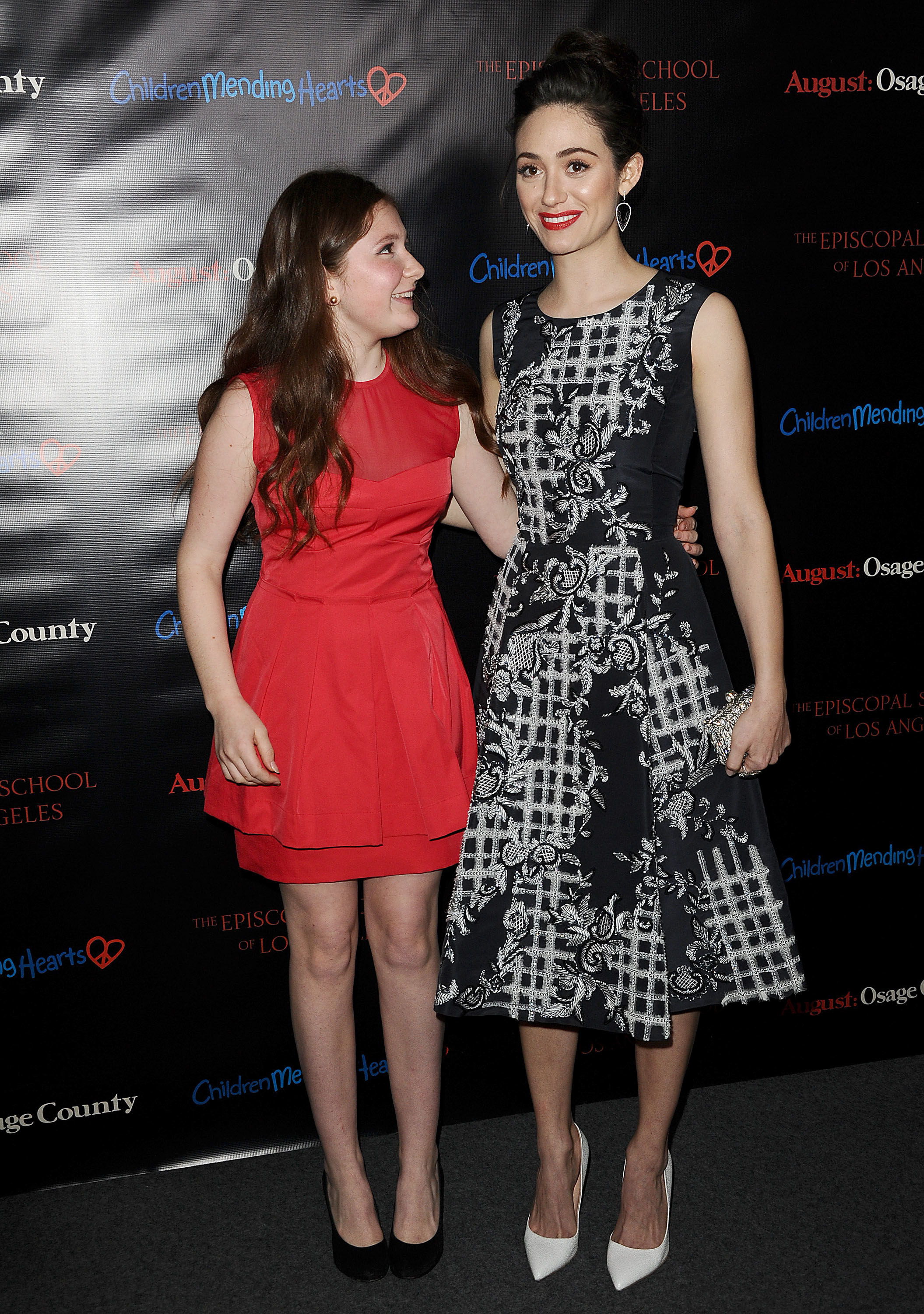 Emma Kenney and Emmy Rossum in dresses at an event