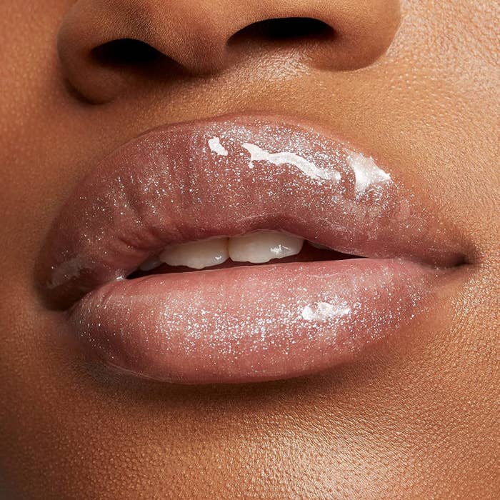 A person wearing the sparkly gloss on their lips