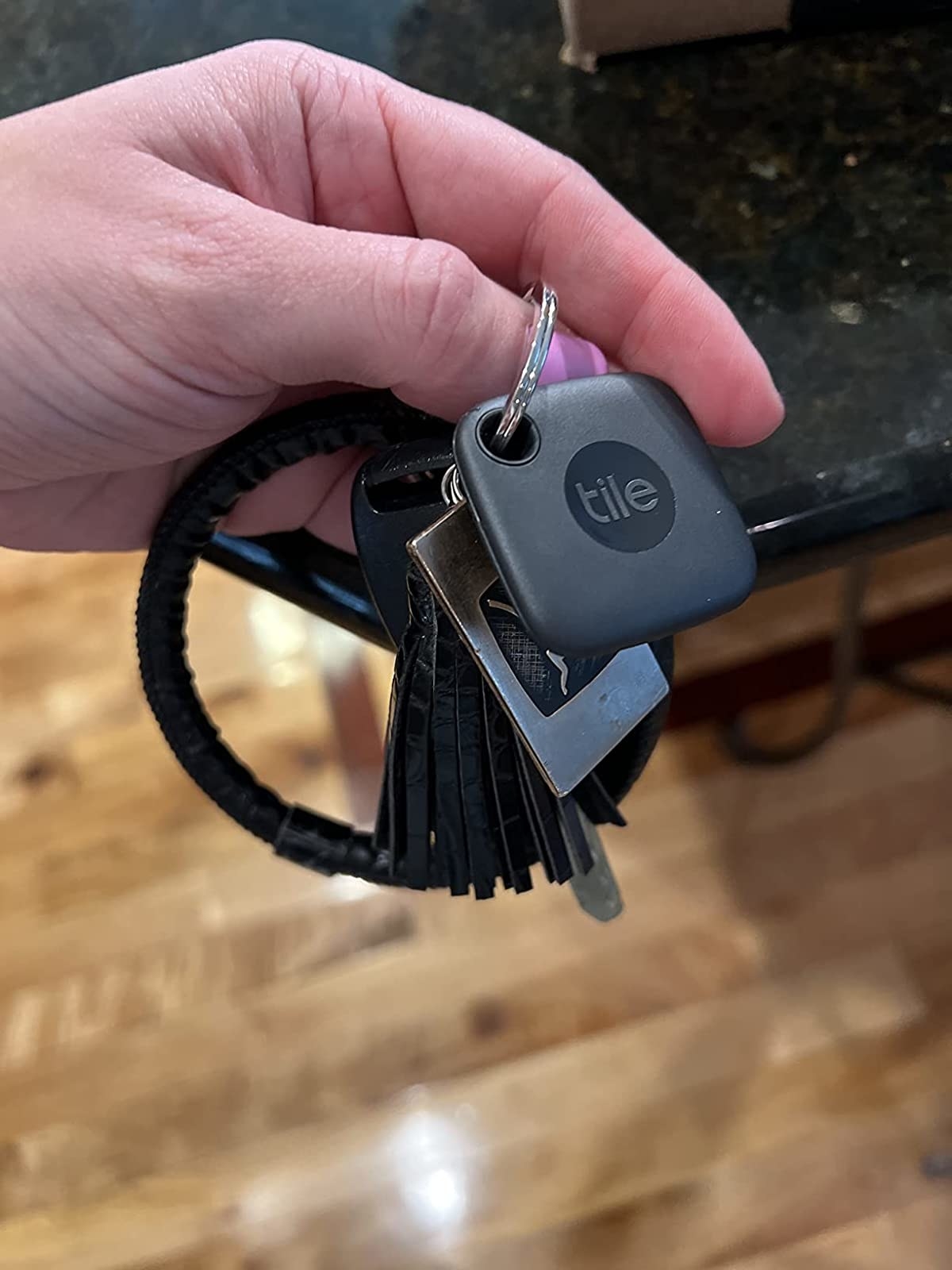 the black square tracker on a keychain