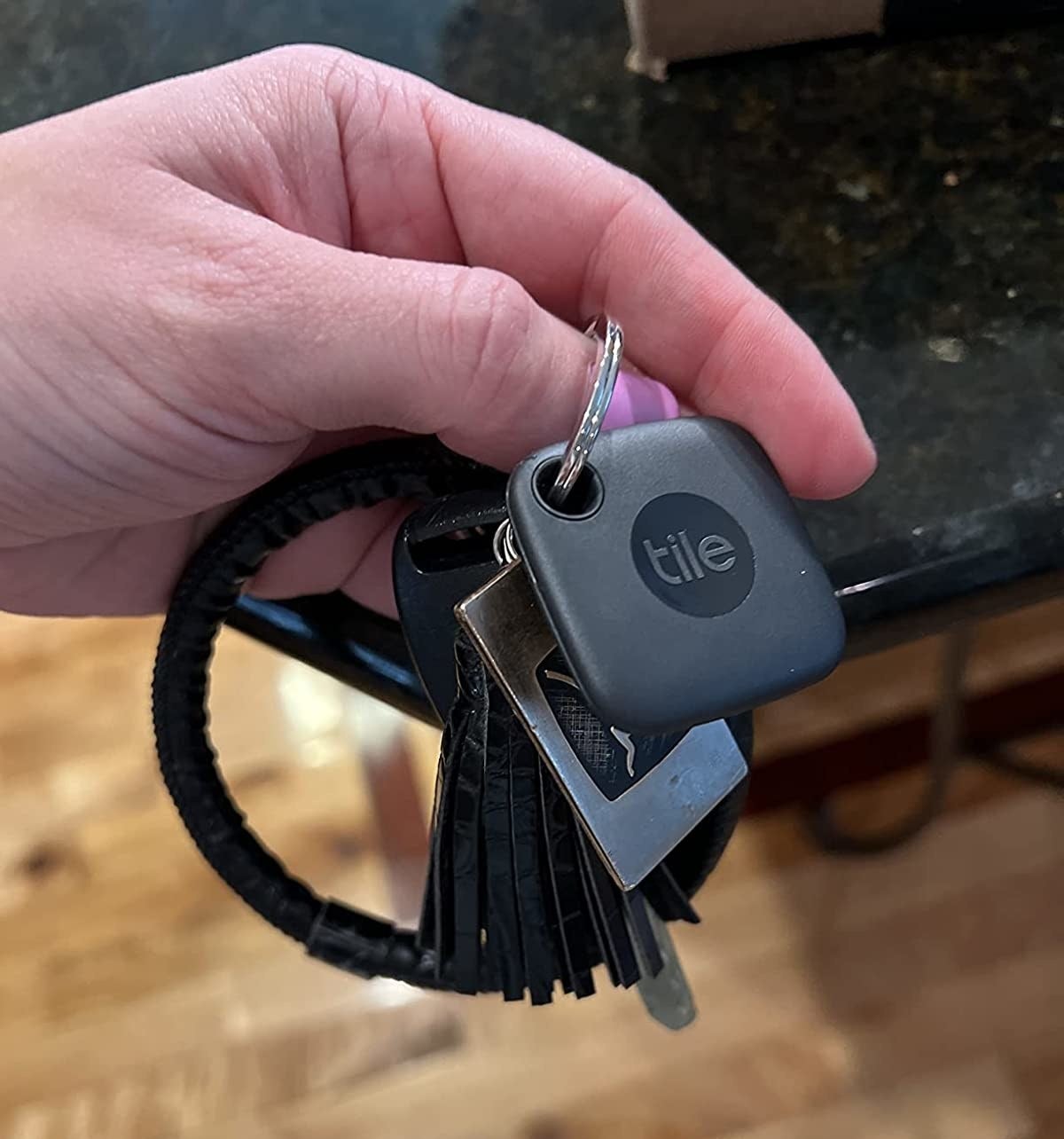 the black square tracker on a keychain