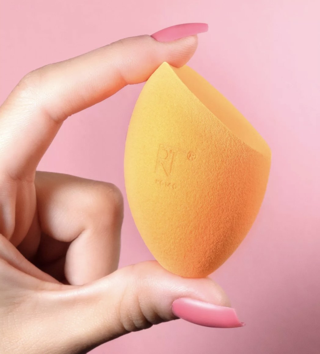 a person holding the sponge in their hand