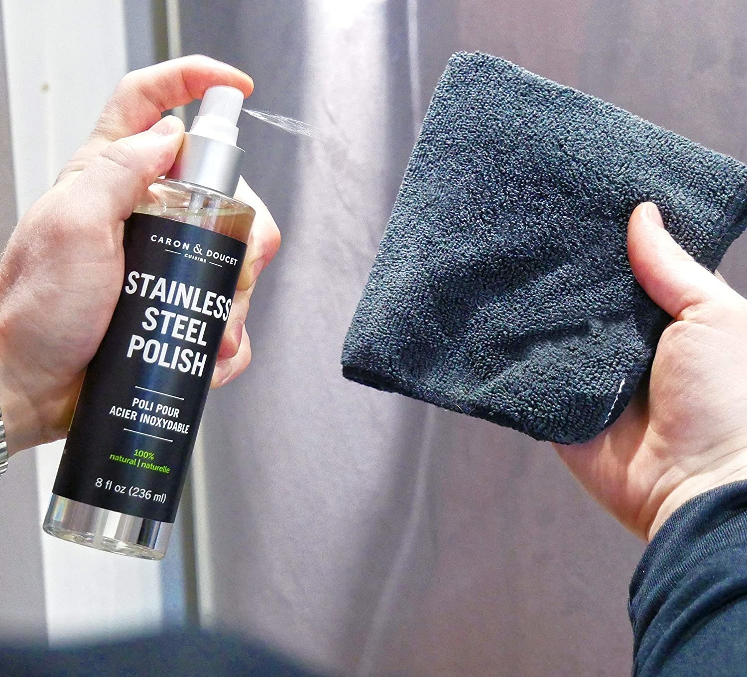 A person spraying the polish onto a rag