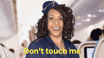 Comedian Holly Logan dressed as a flight attendant says,