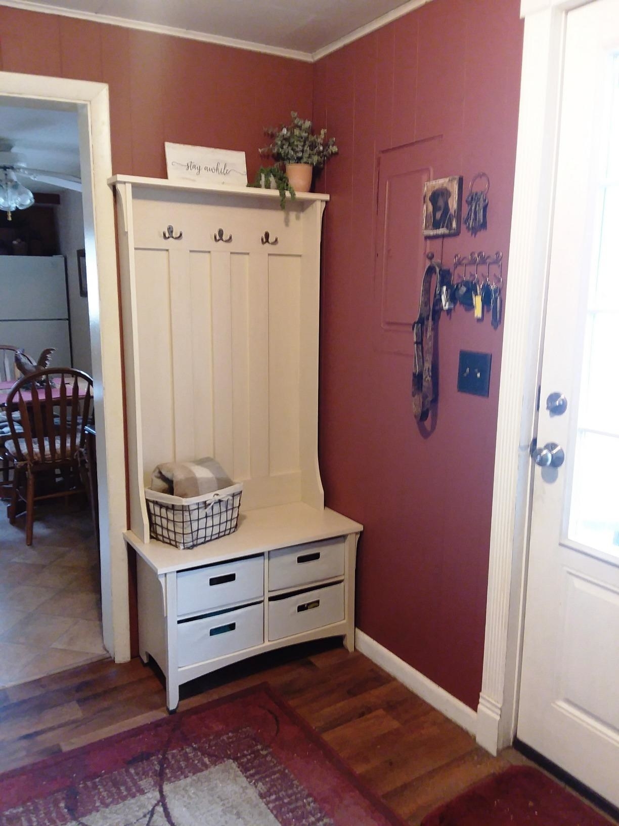 reviewer image of the antique white storage bench in an entryway