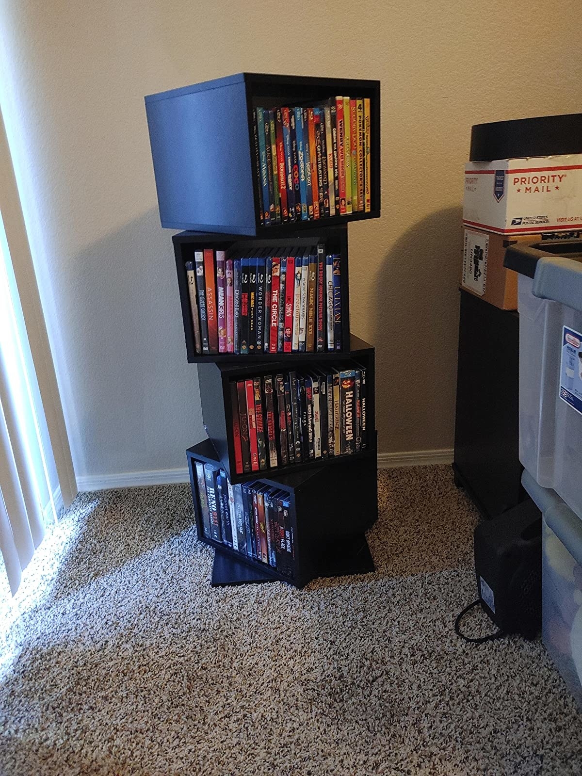 reviewer image of the rotating cube shelving unit with DVDs in each compartment