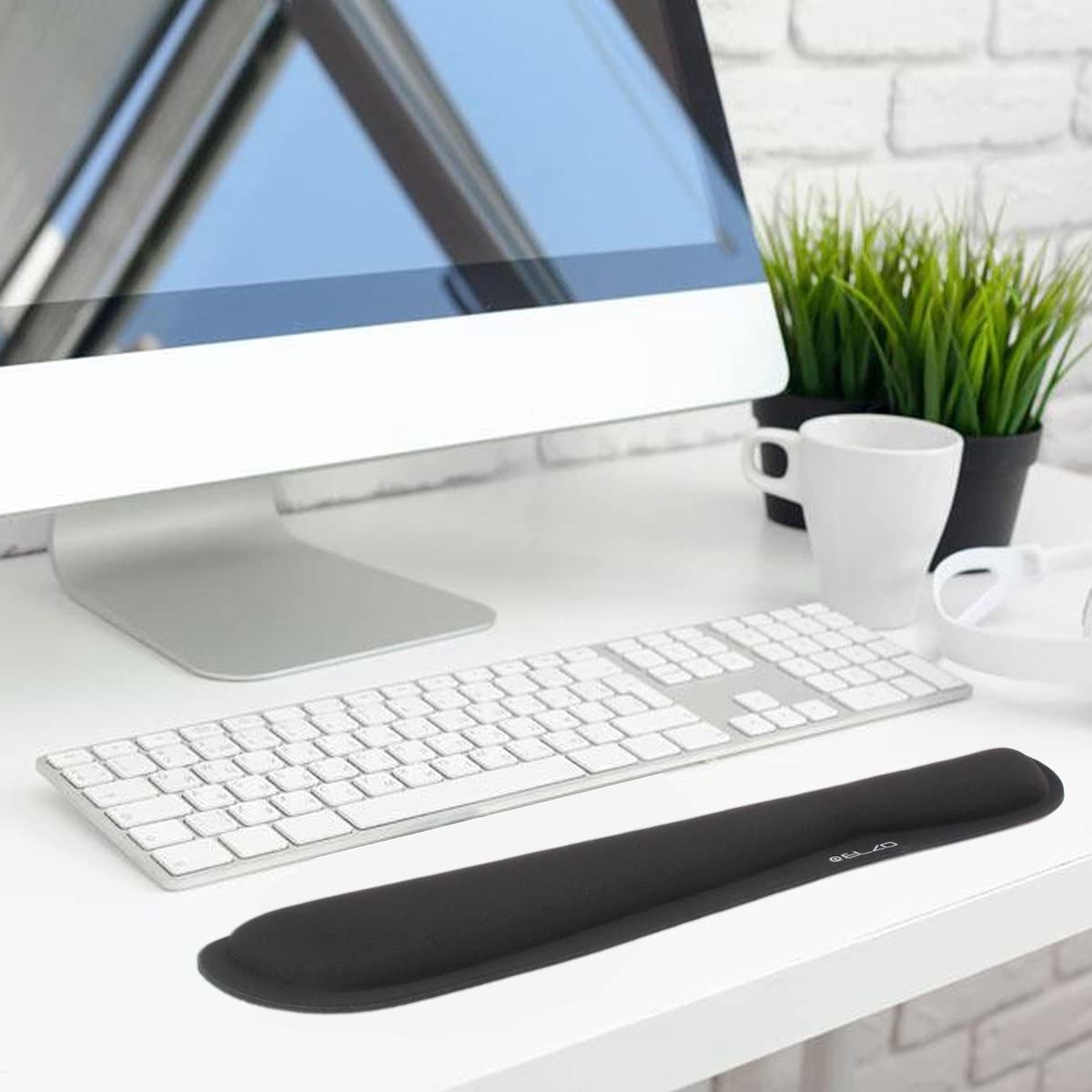 The wrist rest on a desk in front of a keyboard