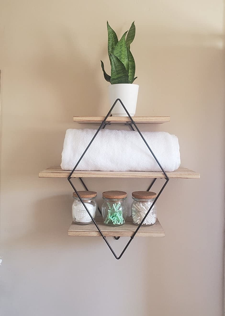 reviewer image of the natural Befayoo Diamond Floating Shelves mounted on a bathroom wall