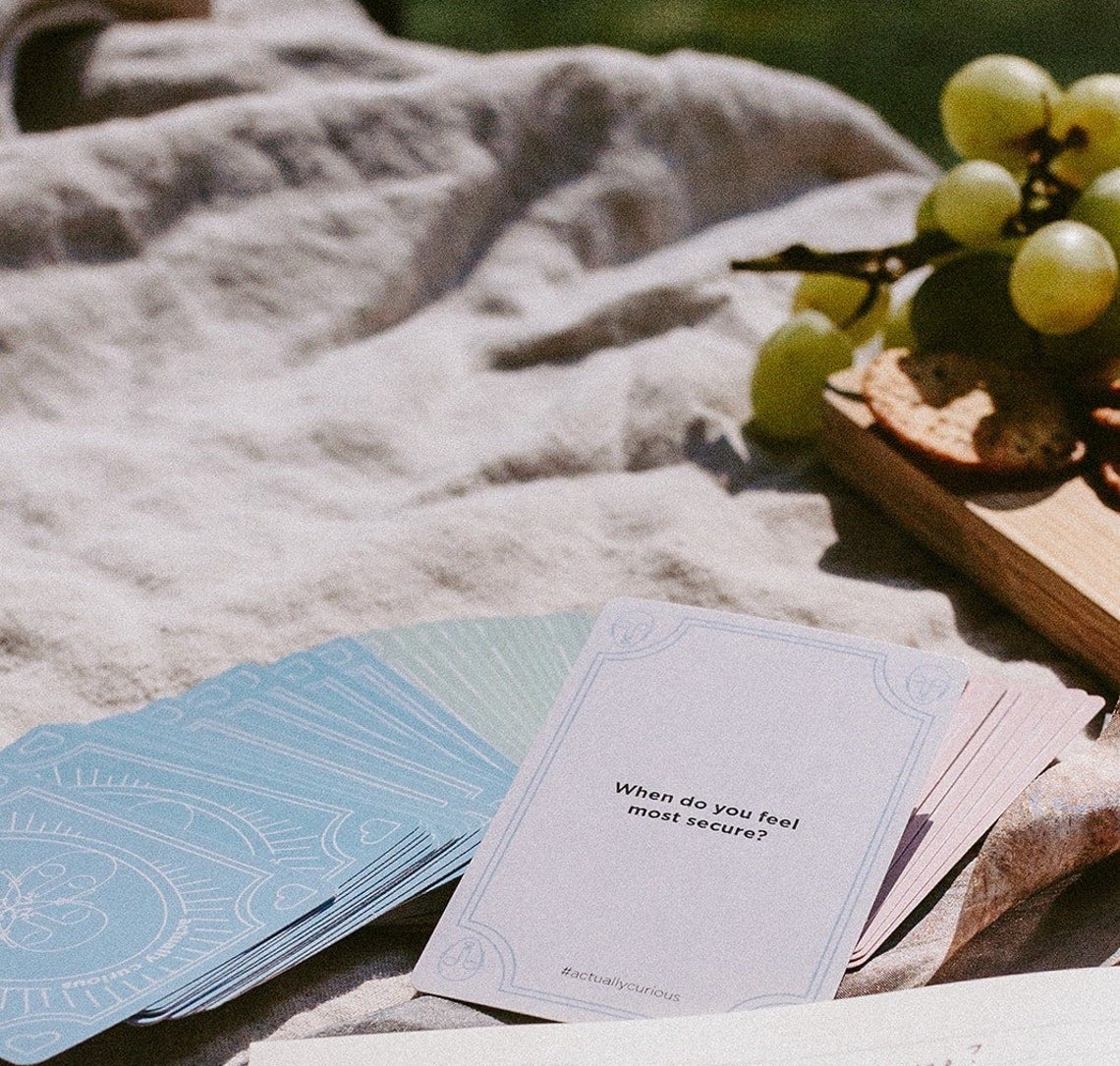 a deck of cards spread out with one flipped over that says "when do you feel most secure?"