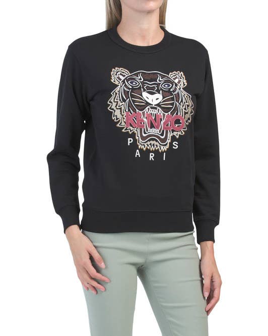 A model wearing the sweatshirt with Kenzo tiger embroidered on the front