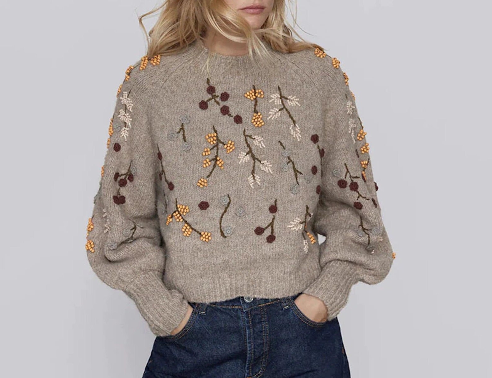 A model wearing the embroidered sweater