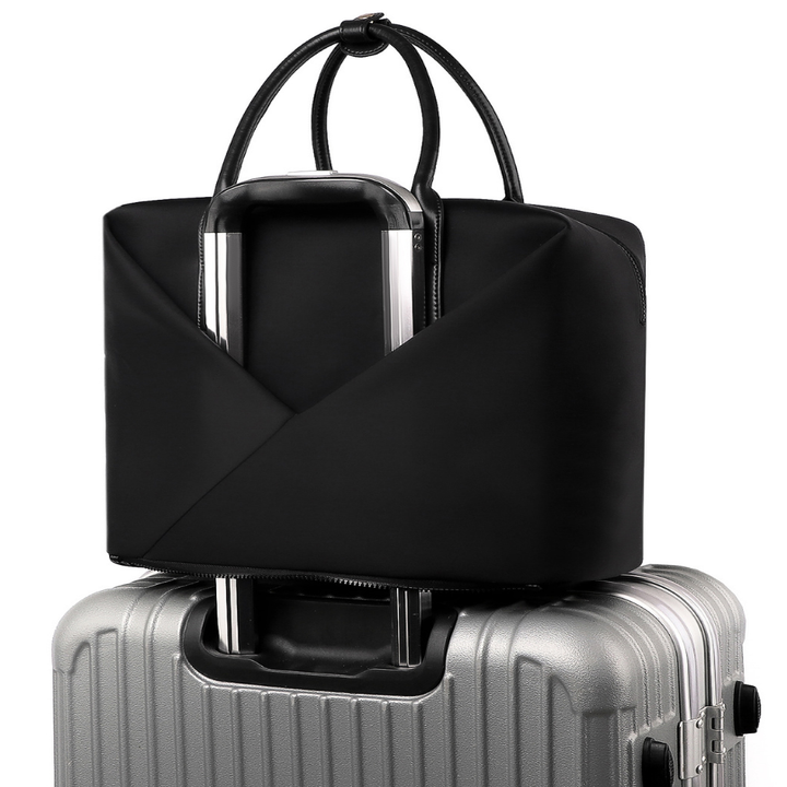 the bag attached to a rolling suitcase