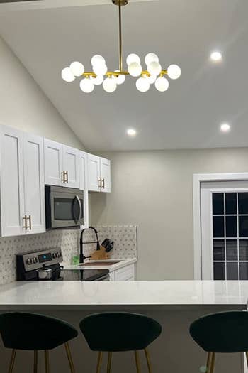 a reviewer's chandelier above the kitchen island