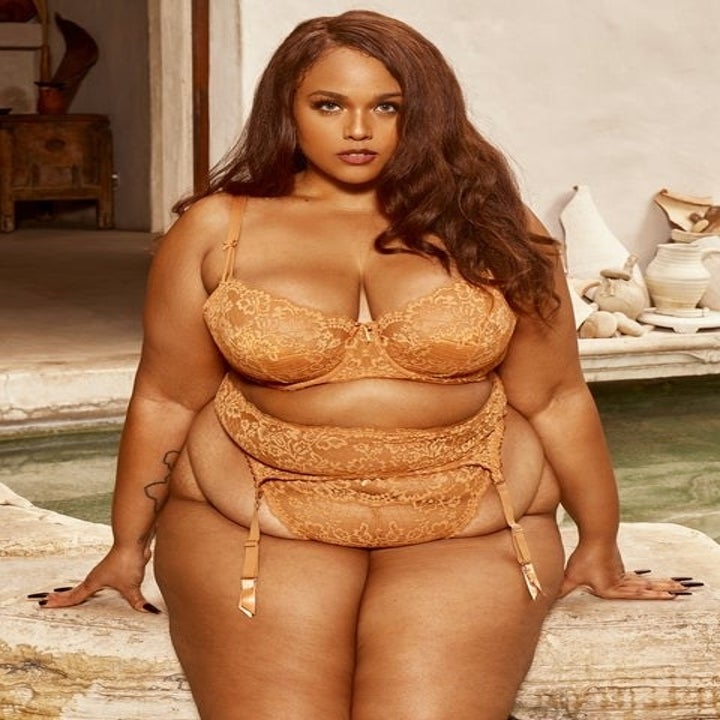 a. model wearing a matching lace bra, garter and thing set
