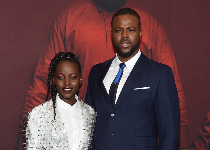 Lupita Nyong&#x27;o and Winston Duke posing together at a premiere