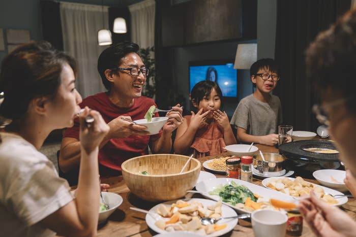 Family enjoying dinner around a table.
