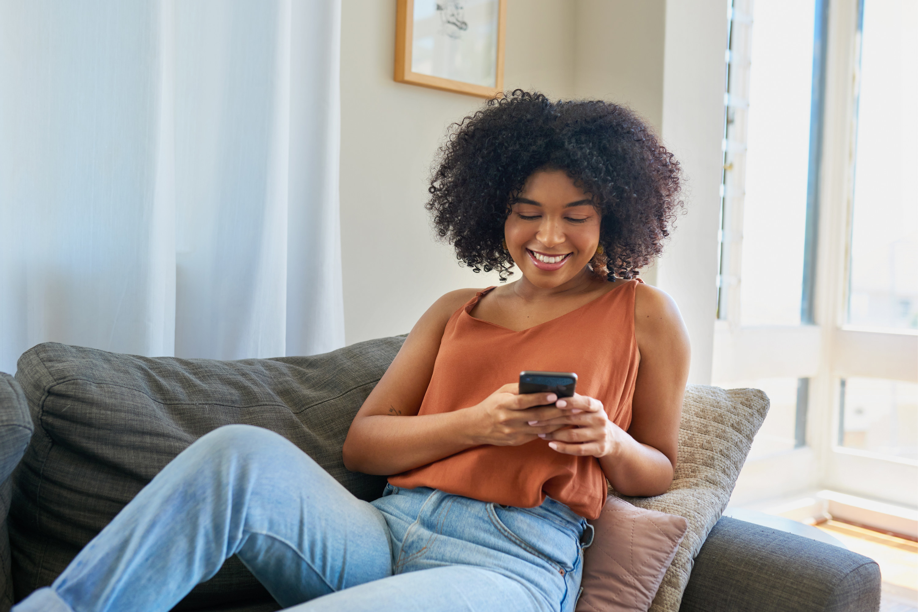 Young woman relaxing and looking at her phone