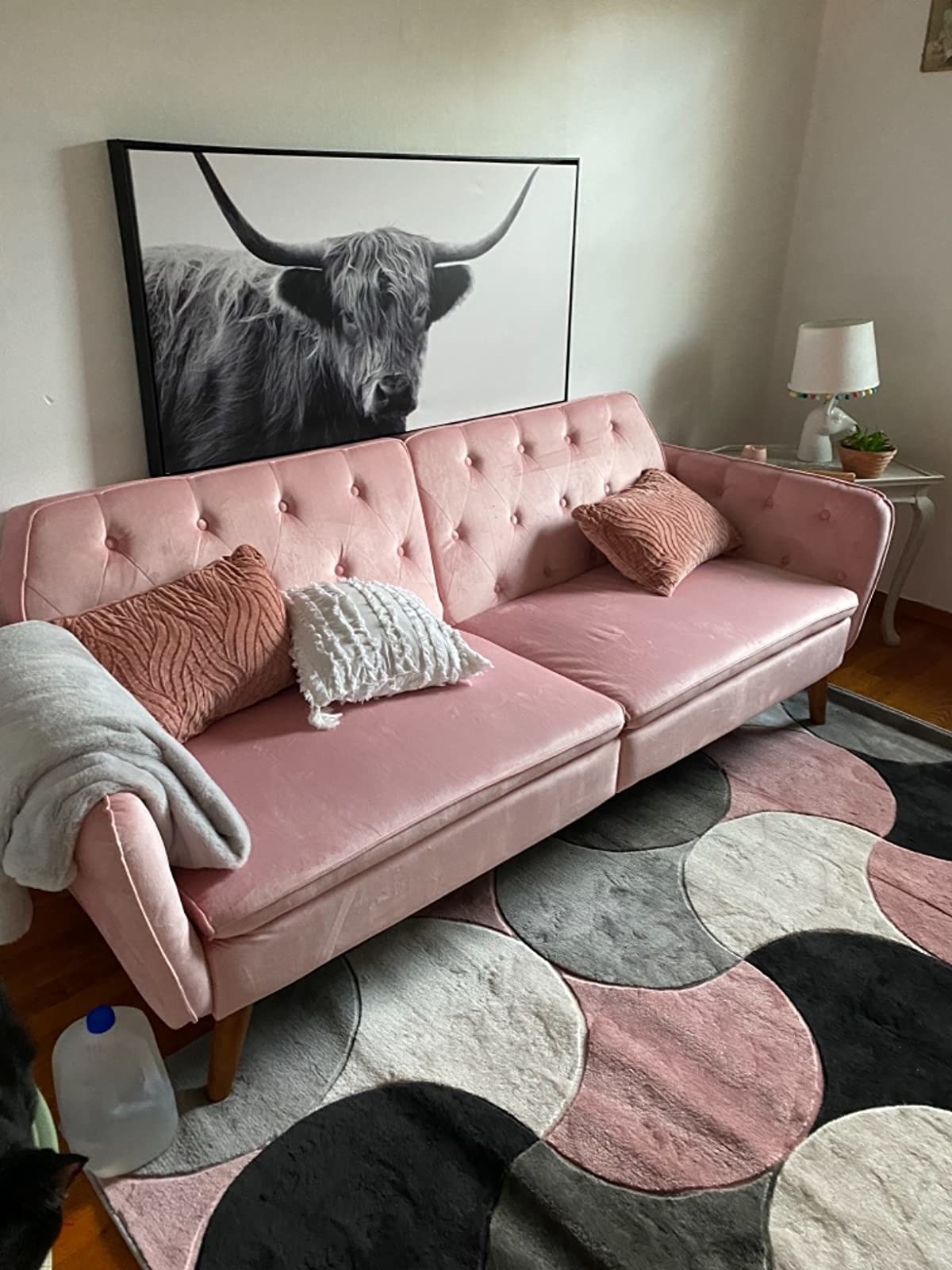 reviewer image of the pink sofa bed in a living room