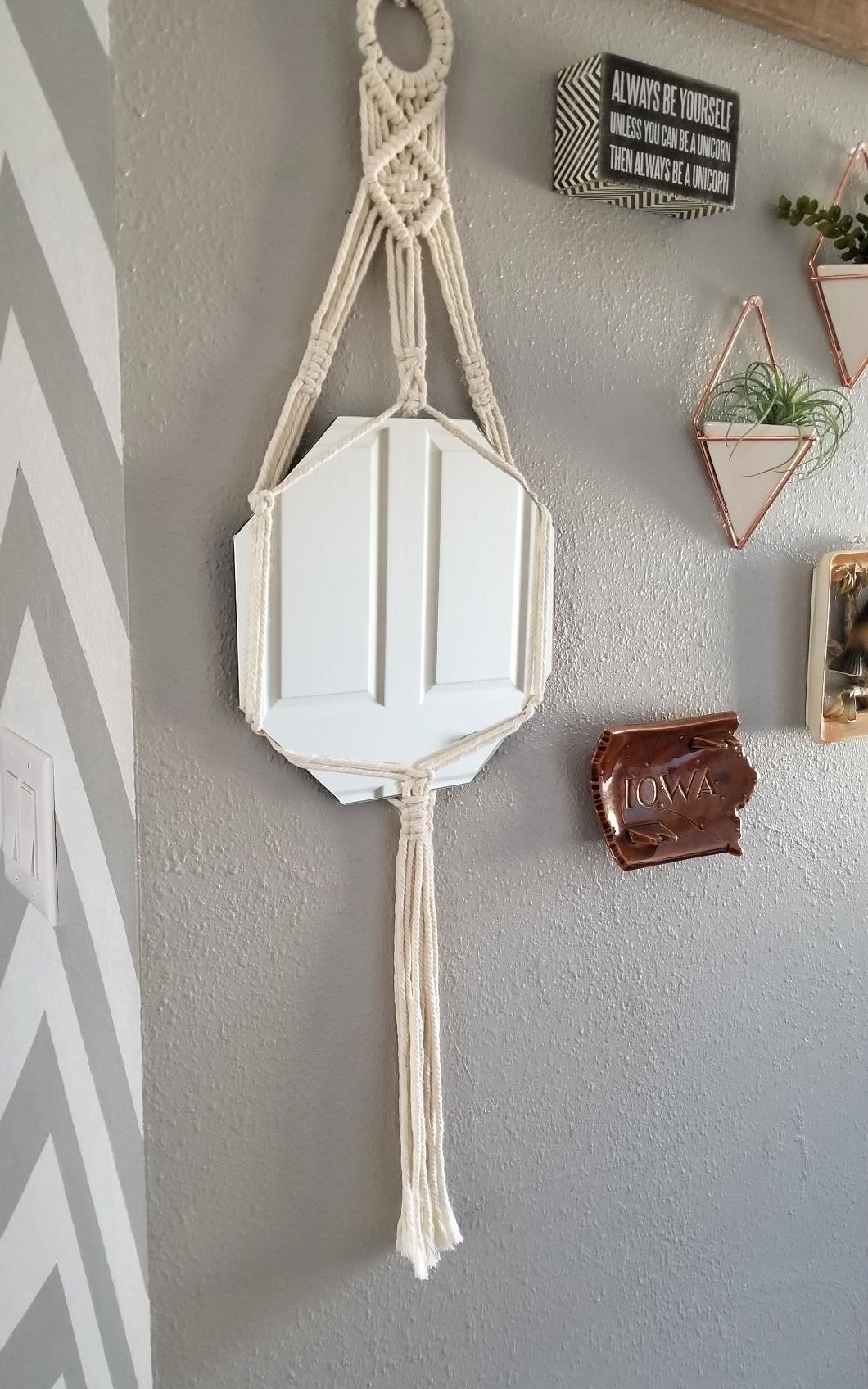 reviewer&#x27;s macrame mirror hanging on their wall