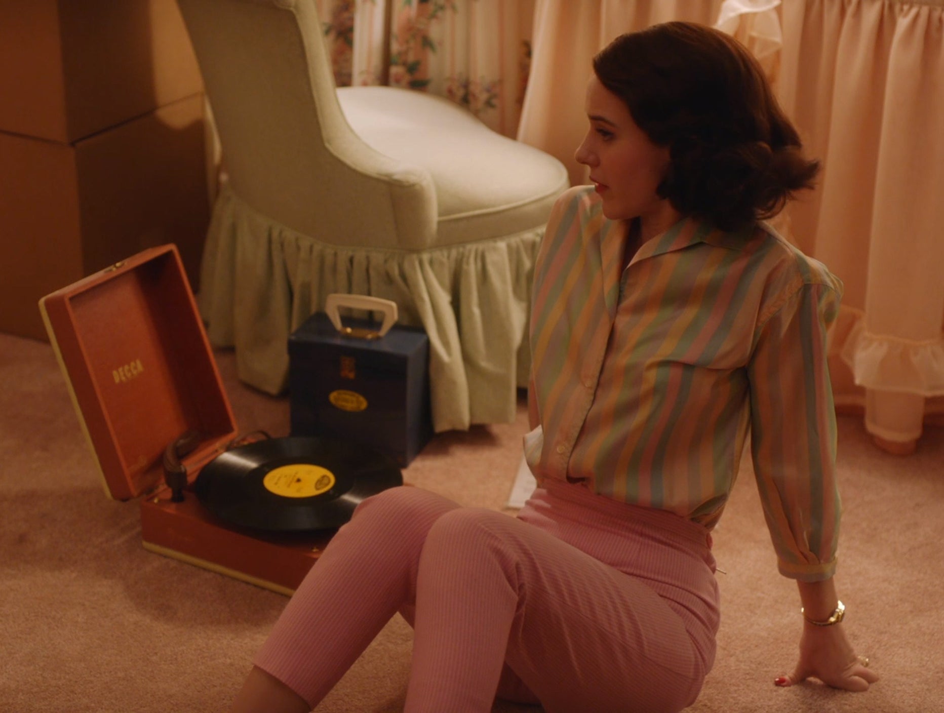 Screenshot from Mrs. Maisel shows Midge sitting on the floor listening to a record