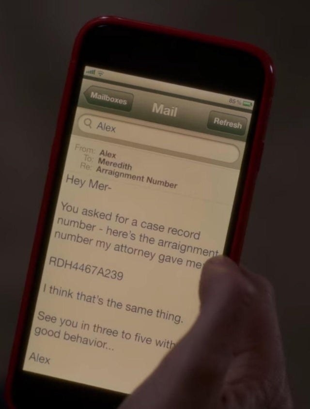 A phone showing an email from Alex to Meredith