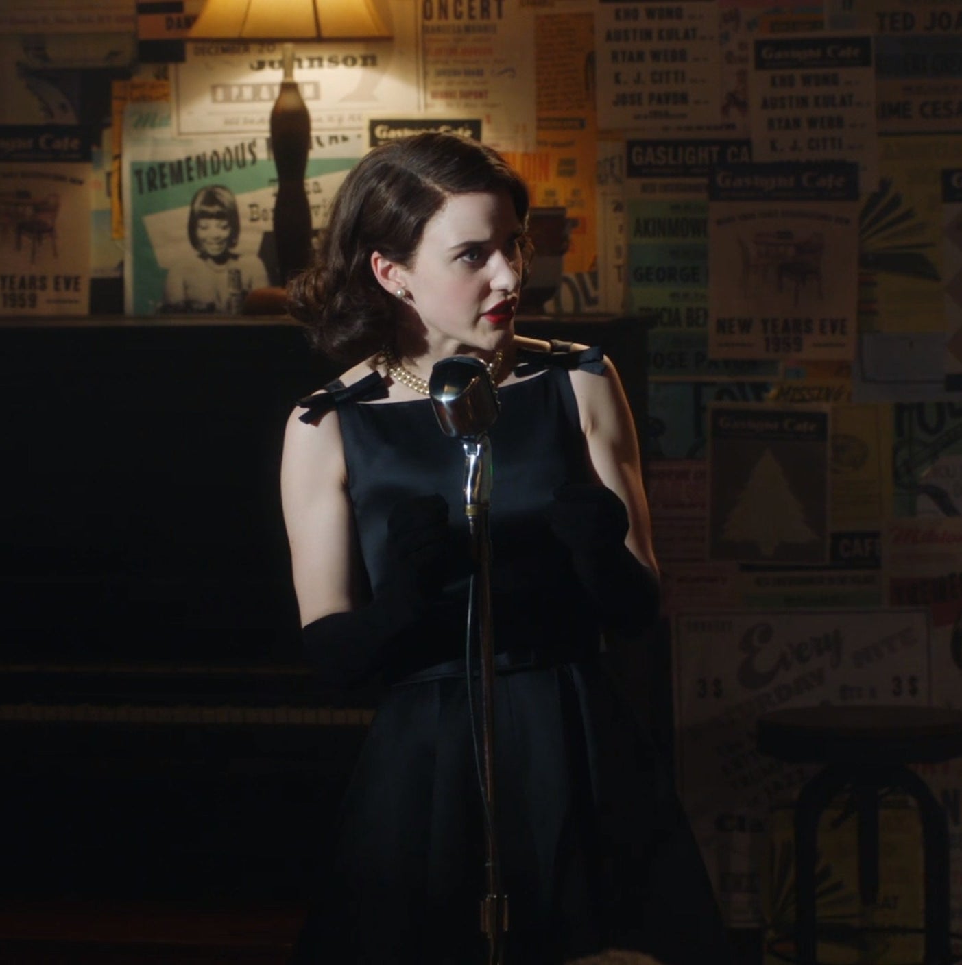 Screenshot from Mrs. Maisel shows Midge in a nice dress on stage