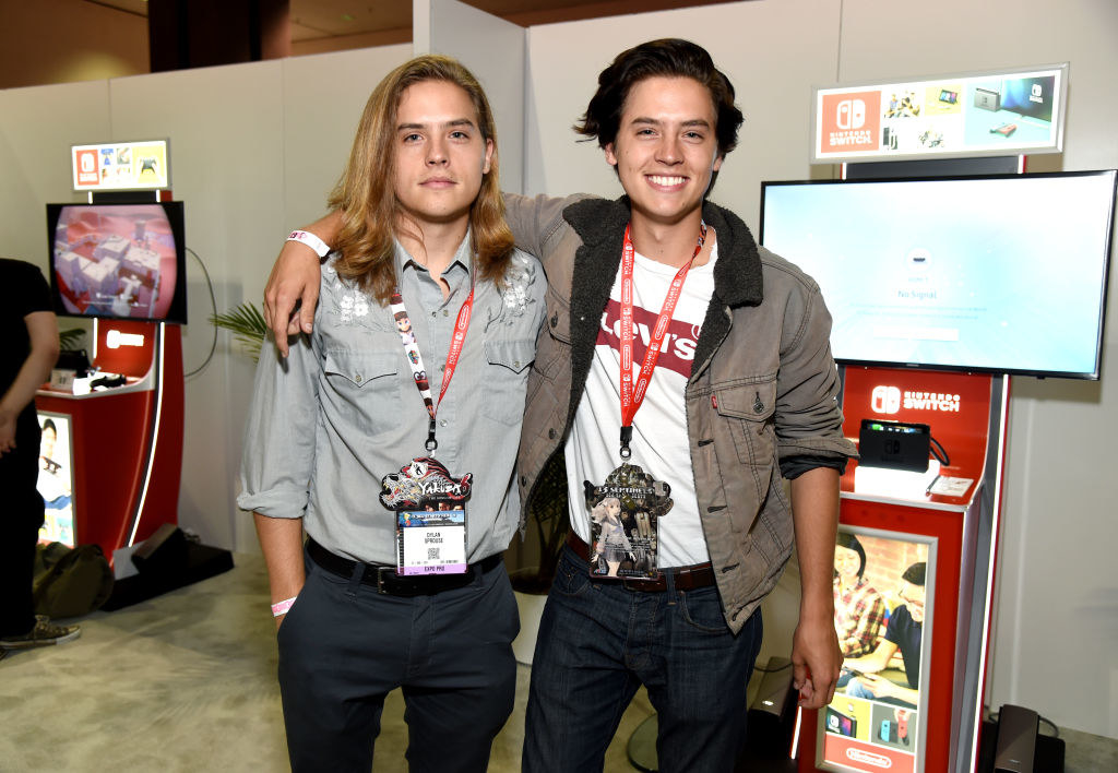 Cole and Dylan Sprouse posing together at a gaming store
