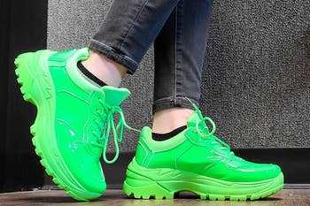 Reviewer wearing neon green chunky platform sneakers