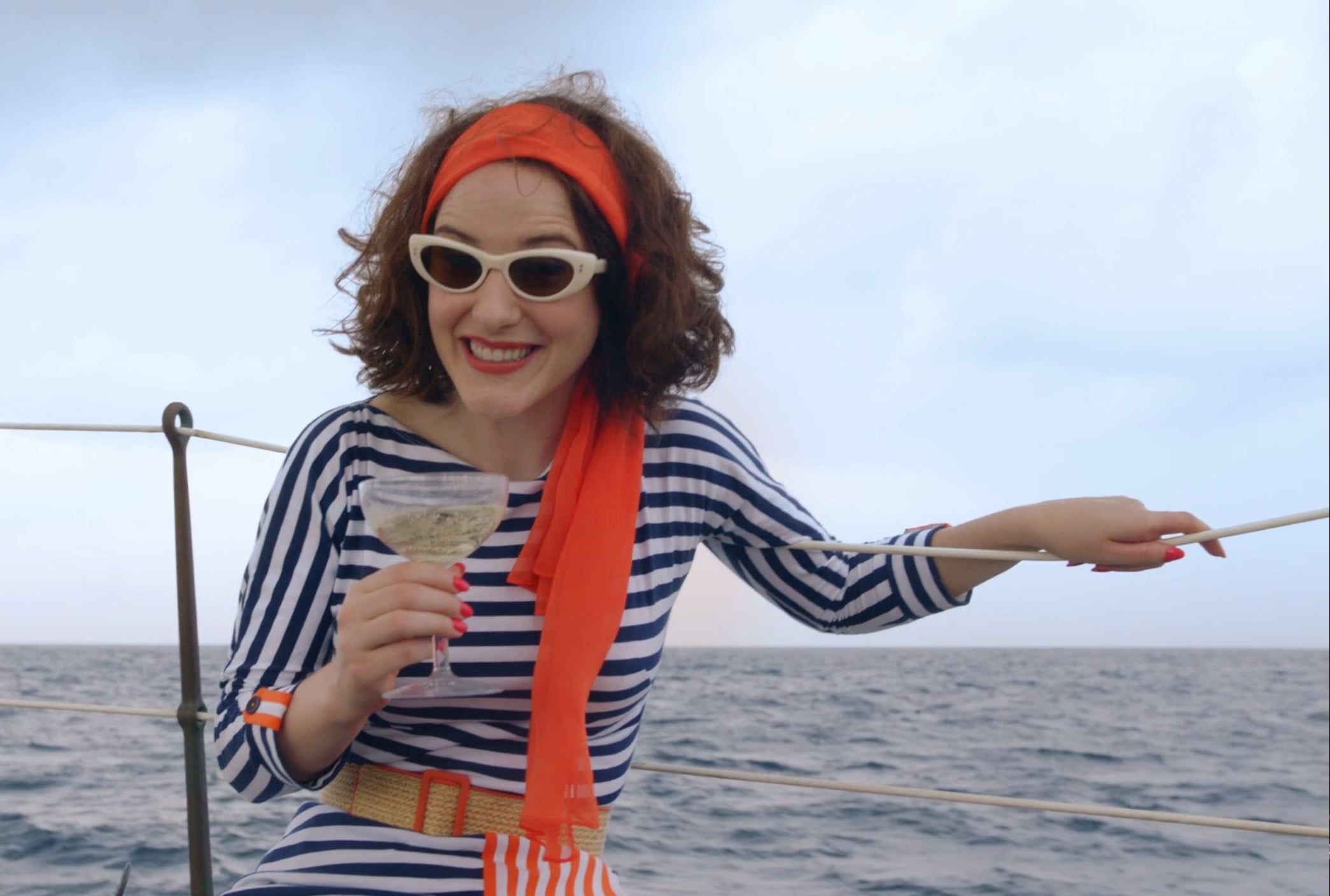 Midge on a boat holding a drink