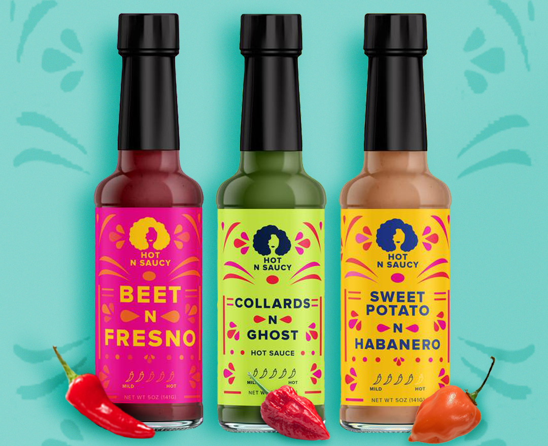 three bottle of hot sauce with labels that read "beet n fresno", "collards n ghost", and "sweet potato n habanero"