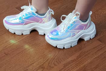 Reviewer wearing hologram chunky platform sneakers