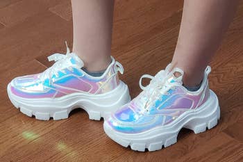 Reviewer wearing hologram chunky platform sneakers