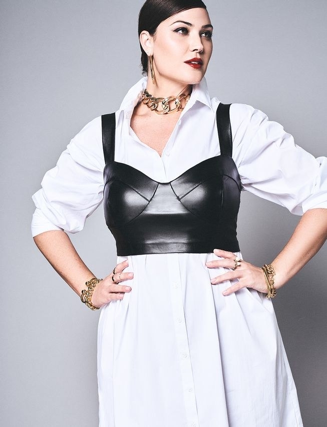 Model wearing faux leather bustier over a white button-down