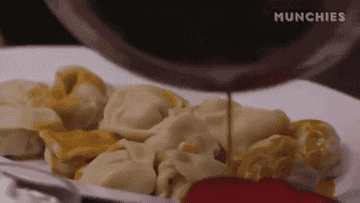 Pouring sauce over stuffed pasta