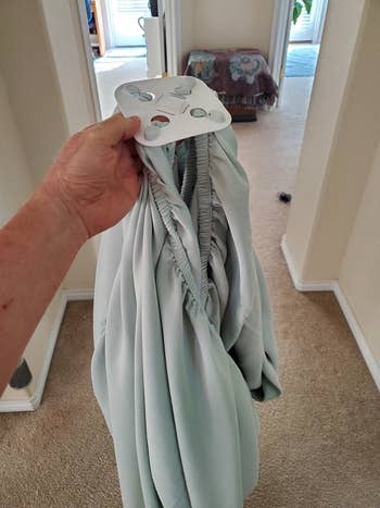 a reviewer holding up the sheets with the pads attached