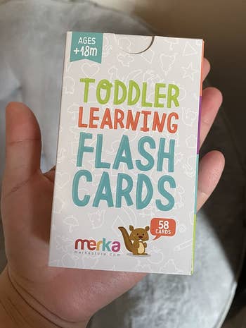 reviewer holding the pack of flash cards