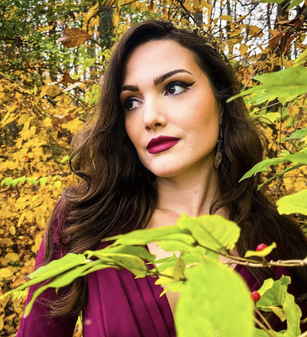 Bonnie poses for a photo in the woods in the fall