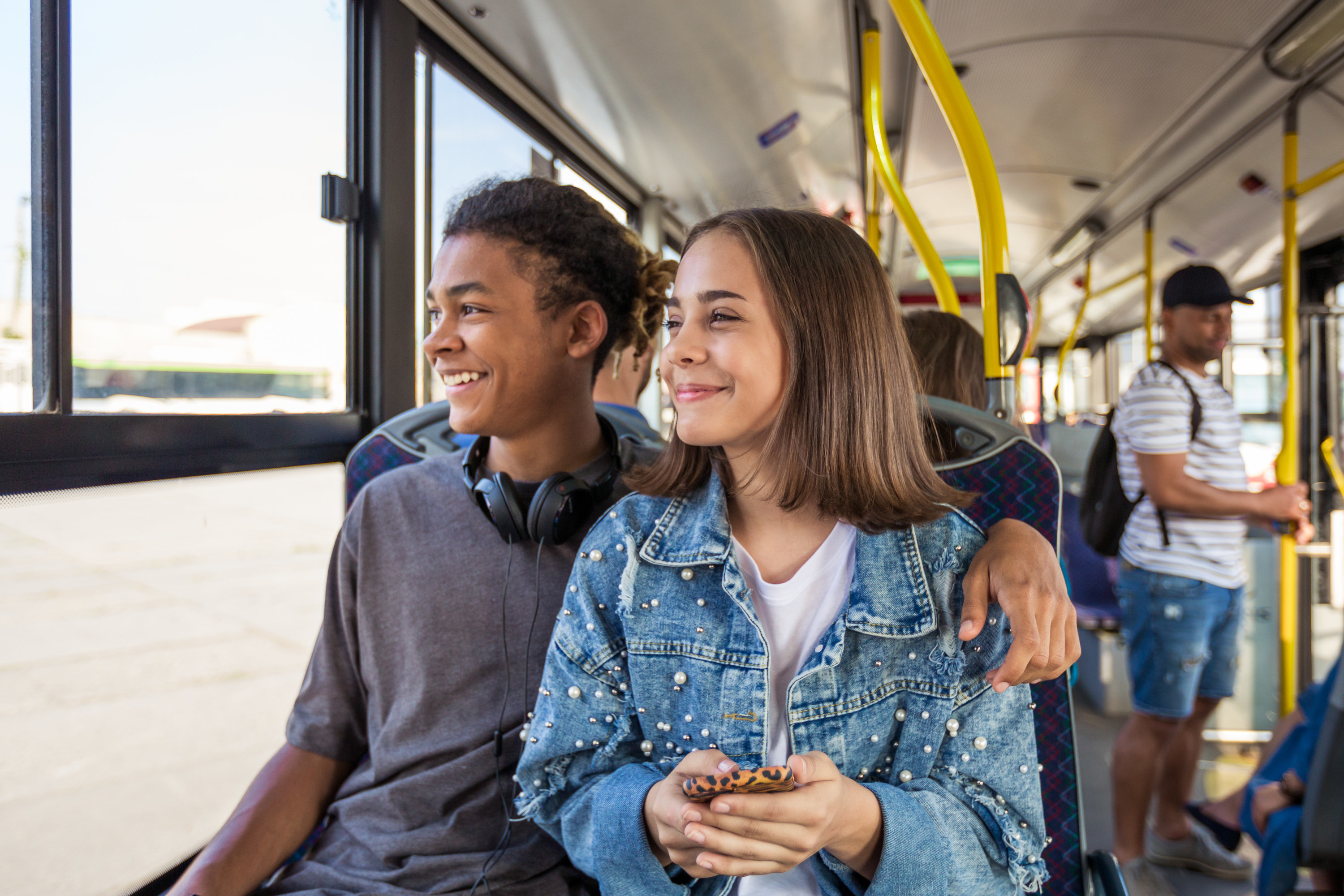 Teenage couple riding the bus
