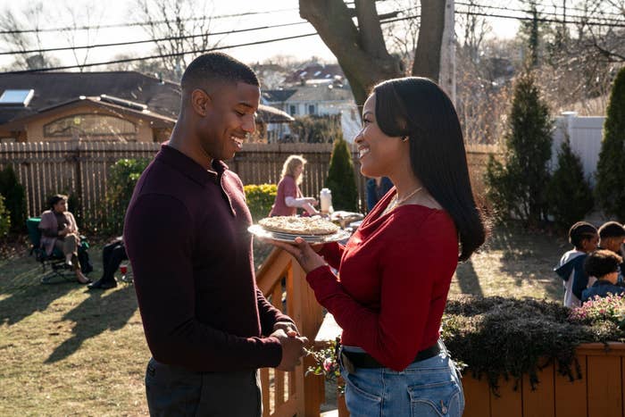Dana has a pie in her hand smiling lovingly at Charles.