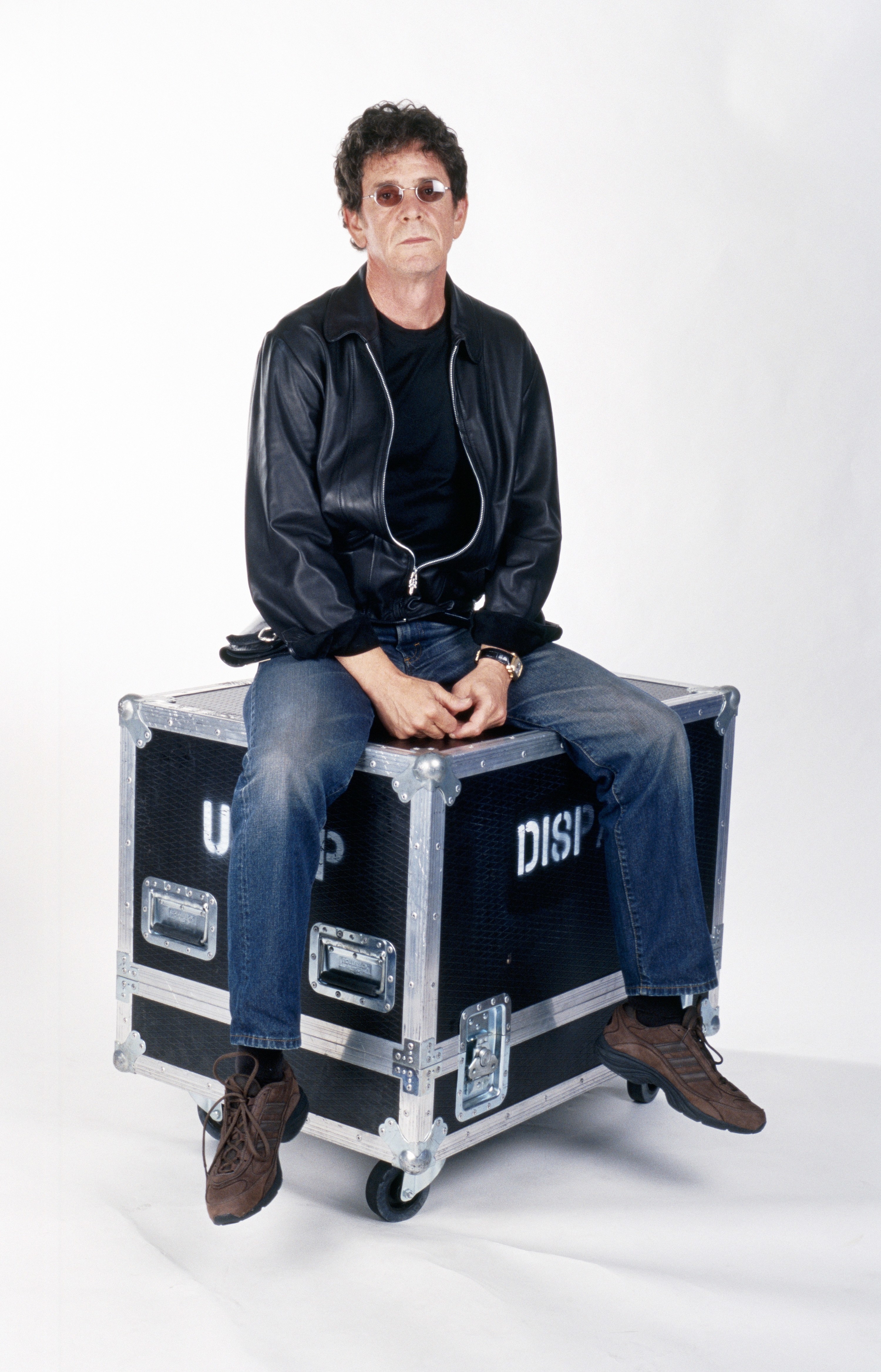 Lou sits on top of a touring road case