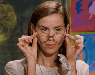 Miss Honey from Matilda looking shocked and pulling her glasses off her face