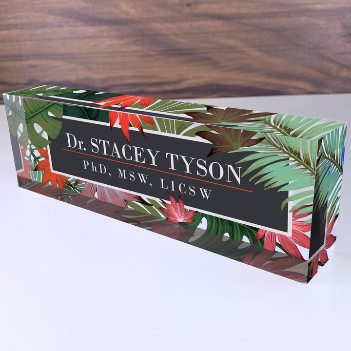 an acrylic block printed with leaves and text reading "Dr. Stacey Tyson, PhD,MSM, LICSW"