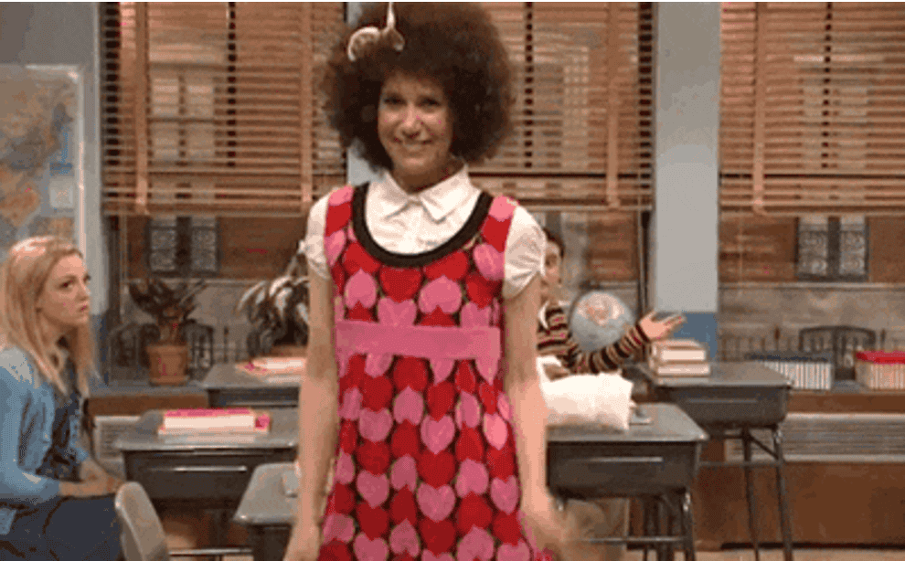 GIF of Kristen Wiig dancing in a heart-print dress on &quot;Saturday Night Live&quot;