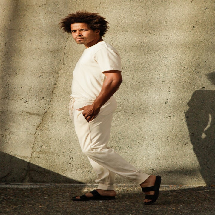 a model wearing a matching off-white short sleeve T-shirt and jogger pants